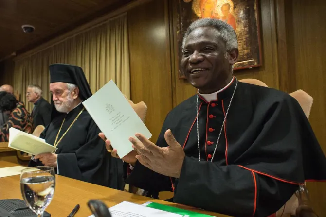 Cardinal Peter Turkson with a copy of Laudato Si at a press conference in Paul VI Hall on June 18 2015 Credit   LOsservatore Romano CNA 6 18 15