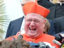 Cardinal Timothy Dolan greets the press in Rome in March 2012.