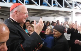Cardinal Dolan greets Iraqis in the village of Inishke before Mass on April 10, 2016.   Elise Harris/CNA.