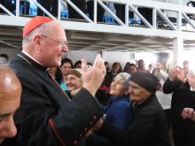 Cardinal Dolan greets Iraqis in the village of Inishke before Mass on April 10, 2016. 