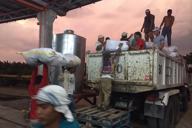 Caritas volunteers loading food packets for typhoon victims Credit Caritas Manila CNA 12 19 14