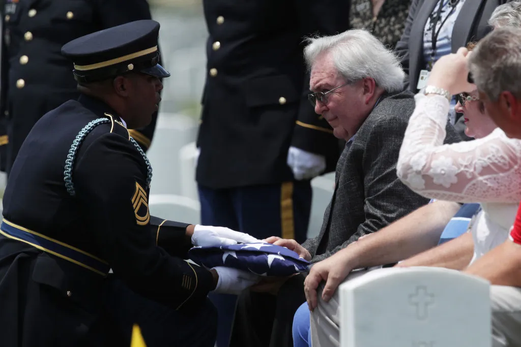 Carl Mann II receives a flag during the funeral of his father, Carl Mann, on the 75th anniversary of the D-Day invasion, June 6, 2019, at Arlington National Cemetery. ?w=200&h=150