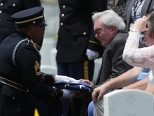 Carl Mann II receives a flag during the funeral of his father, Carl Mann, on the 75th anniversary of the D-Day invasion, June 6, 2019, at Arlington National Cemetery. 