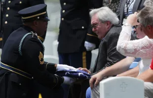 Carl Mann II receives a flag during the funeral of his father, Carl Mann, on the 75th anniversary of the D-Day invasion, June 6, 2019, at Arlington National Cemetery.   Alex Wong/Getty Images.
