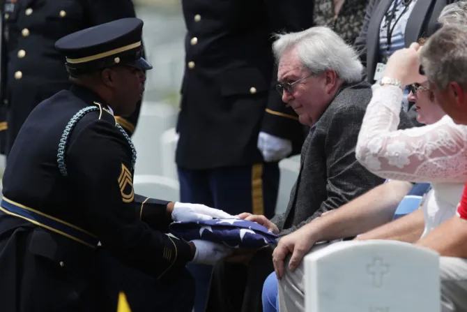 Carl Mann II receives a flag during the funeral of his father Carl Mann on the 75th anniversary of the D Day invasion June 6 2019 at Arlington National Cemetery Credit Alex Wong Getty Images