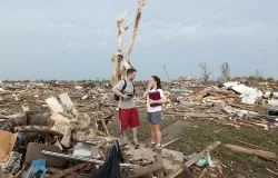 Carlos and Kim Caudillo stand in the debris of their home after a powerful tornado ripped through the area on May 20, 2013 in Moore, Okla. ?w=200&h=150