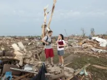 Carlos and Kim Caudillo stand in the debris of their home after a powerful tornado ripped through the area on May 20, 2013 in Moore, Okla. 
