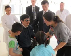 Chen Guangcheng meets his family at the Chaoyang hospital in Beijing as US Ambassador to China Gary Locke looks on. ?w=200&h=150