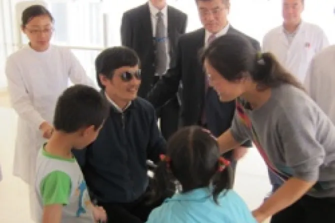 Chen Guangcheng meets his family at the Chaoyang hospital in Beijing as US Ambassador to China Gary Locke looks on Credit US Embassy Beijing CNA China Catholic News 5 2 12