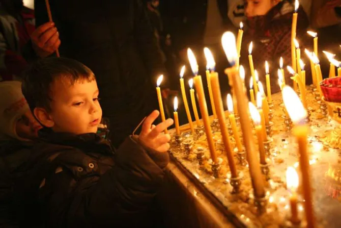 Children light candles at Christmas Mass Credit haak78 Shutterstock CNA