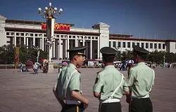 Chinese officers patrol Tiananmen Square in Beijing, where hundreds of pro-democracy protestors were killed June 4, 1989. ?w=200&h=150