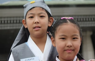 Choi Woo-jin (L) and his sister Choi Seung-won (R) speak with CNA after delivering flowers to Pope Francis upon his arrival in Seoul, South Korea on Aug. 14, 2014.   Alan Holdren/CNA.