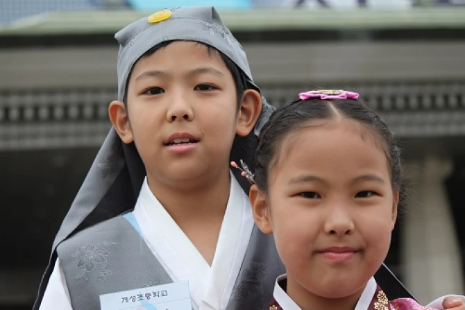 Choi Woo jin L and his sister Choi Seung won R speak with CNA after delivering flowers to Pope Francis upon his arrival in Seoul South Korea on Aug 14 2014 Credit Alan Holdren CNA