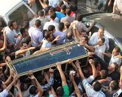 Christians carry the coffin of a man on October 10, 2011. ?w=200&h=150