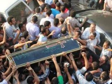 Christians carry the coffin of a man on October 10, 2011. 