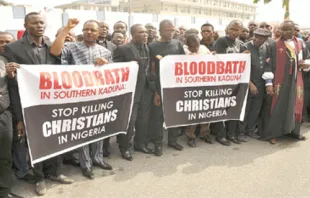 Christians hold signs as they march on the streets of Abuja during prayer and penance for peace and security in Nigeria on March 1, 2020. 
