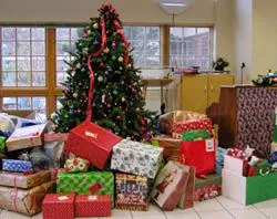 Donated gifts stand under a tree during a Christmas gift drive.?w=200&h=150