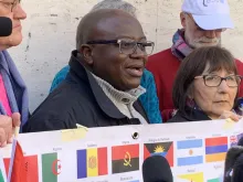 Benjamin Kitobo (C) speaks at a gathering of clerical sex abuse victims and advocates outside St. Peter's Square, Feb. 20, 2019. 