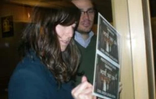 A married couple signs the postcard from the Colorado Catholic Conference at Holy Name parish in Sheridan, Colo. on Jan. 15, 2012