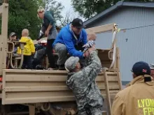 Colorado National Guardsmen assist Boulder County authorities evacuate residents of Lyons, CO Sept. 13, 2013. 