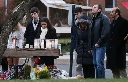 A makeshift memorial outside St. Rose of Lima Catholic Church draws mourners on Dec. 16 after the mass shooting at Sandy Hook Elementary in Newtown.?w=200&h=150