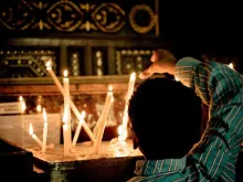 A Coptic Christian boy lights a candle at a church in Cairo. 