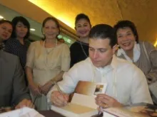Fernando Sanchez Campos, Costa Rican ambassador to the Holy See, signs copies of his new book in Manila. 