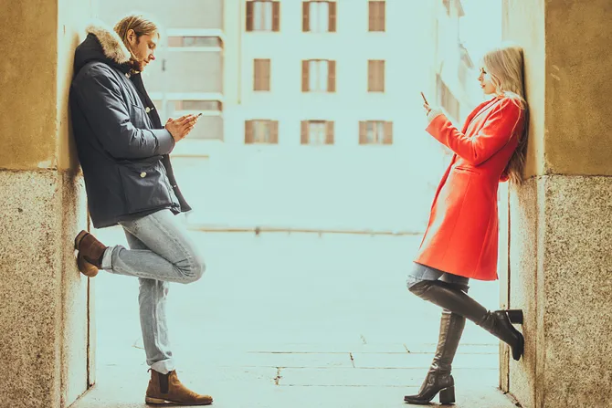 Couple on phones Credit oneinchpunch Shutterstock CNA