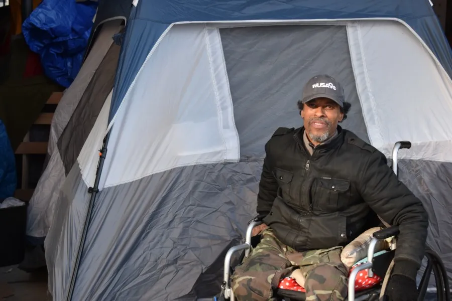Mike Harris, who was one of the people displaced from K Street, poses for a picture in front of his tent under L Street. ?w=200&h=150