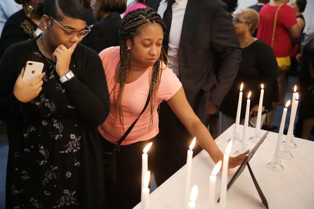 Dashae Wade (L) and Candace Grimes attend a memorial service at Piney Grove Baptist Church in Virginia Beach, Va., June 2, 2019. ?w=200&h=150