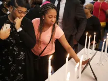 Dashae Wade (L) and Candace Grimes attend a memorial service at Piney Grove Baptist Church in Virginia Beach, Va., June 2, 2019. 