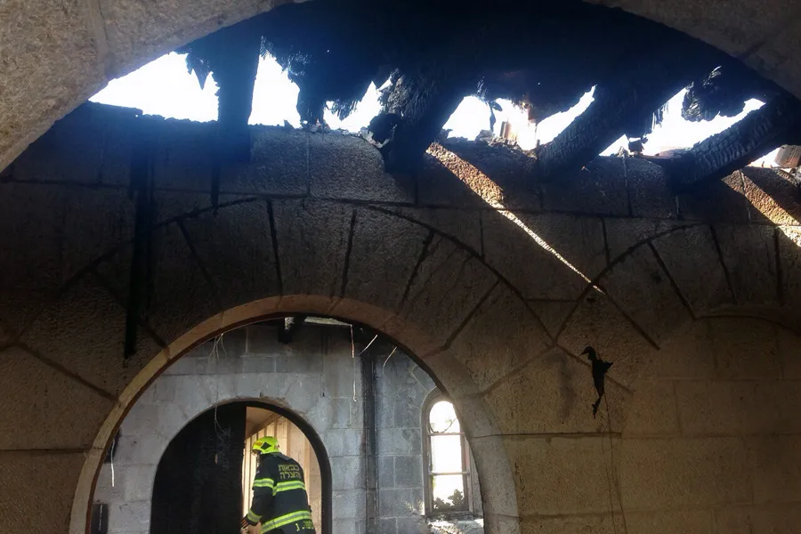 A firefighter surveys the devastation following an arson attack on the Church of the Multiplication in Tabgha, Israel, June 18, 2015. ?w=200&h=150