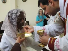Dona Penha, 101, receives First Communion. 