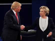 Donald Trump shakes hands with Hillary Clinton during the town hall debate at Washington University on October 9, 2016. 