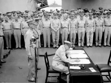 Douglas MacArthur, a US general, signs the Japanese Instrument of Surrender aboard the USS Missouri, Sept. 2, 1945, formally ending World War II. 