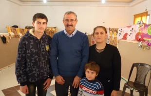 Imad Ibraheem Daood with his wife Sajida and their four children, in a refugee center in Amman.   Kevin J. Jones/CNA.