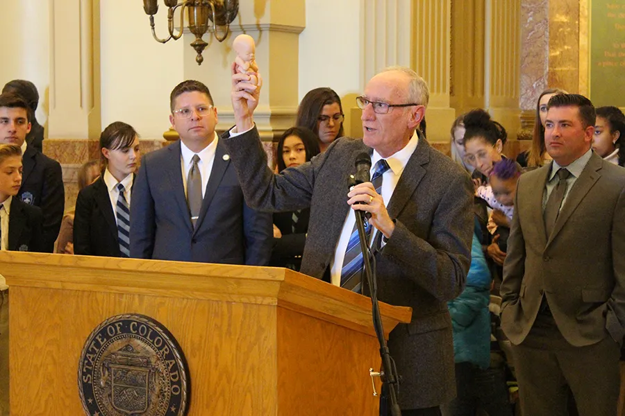 Dr. Tom Perille, president of Colorado's chapter of Democrats for Life, displays a model of a seven-month-old fetus at the Colorado capitol, Feb. 11, 2020. ?w=200&h=150