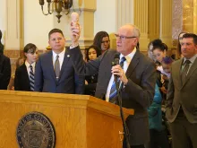 Dr. Tom Perille, president of Colorado's chapter of Democrats for Life, displays a model of a seven-month-old fetus at the Colorado capitol, Feb. 11, 2020. 