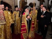 Ecumenical Patriarch Bartholomew exits the Patriarchal Church of St. George to greet Pope Francis. 