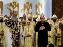 Egyptian President Abdel Fattah al-Sisi speaks near Tawadros II during a Liturgy at Nativity of Christ Cathedral in Egypt's administrative capital, Jan. 2, 2020. 