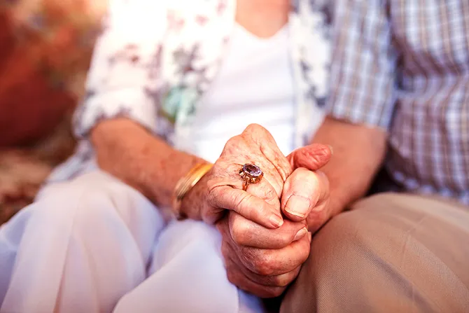 Elderly couple holding hands Credit Jacob Lund Shutterstock CNA