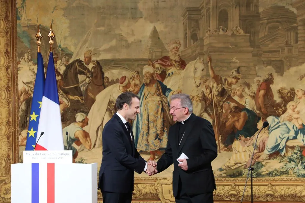 French president Emmanuel Macron (L) greets Archbishop Luigi Ventura, Apostolic Nuncio to France, in Paris, Jan. 4, 2018. ?w=200&h=150