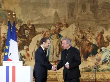 French president Emmanuel Macron (L) greets Archbishop Luigi Ventura, Apostolic Nuncio to France, in Paris, Jan. 4, 2018. 