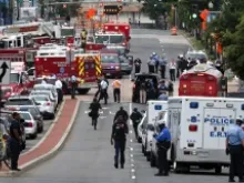 Emergency vehicles and law enforcement personnel respond to shots at the Washington Navy Yard Sept. 16, 2013. 
