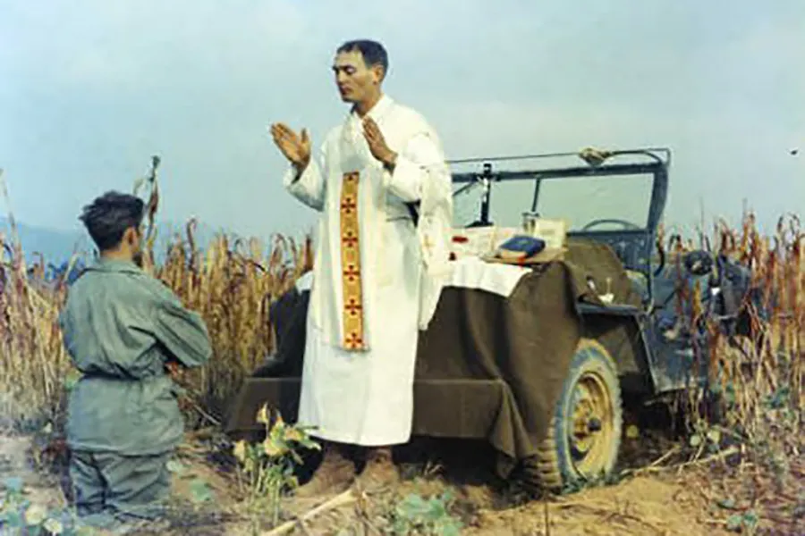 Father Emil Kapaun celebrating Mass using the hood of a jeep as his altar, Oct. 7, 1950. Public domain.?w=200&h=150