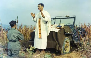 Father Emil Kapaun celebrating Mass using the hood of a jeep as his altar, Oct. 7, 1950. Public domain. null