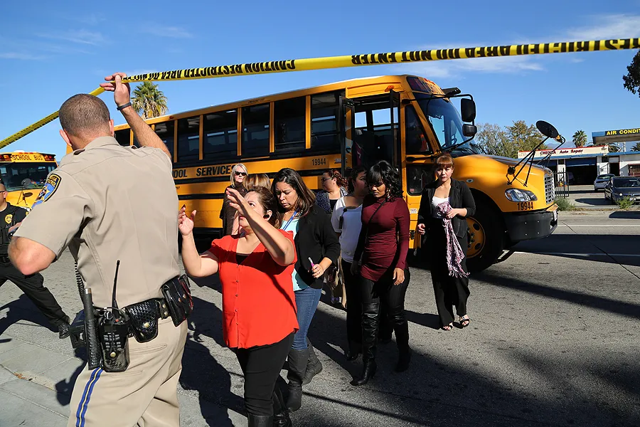 Employees evacuated by bus from site of mass shootings at Inland Regional Center in San Bernardino, Calif. on Dec. 2, 2015. ?w=200&h=150