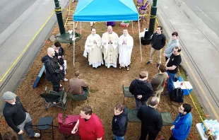 Fr. Jim Wehner and seminarians from Notre Dame Seminary in New Orleans celebrate Mass along the route of the Endymion parade. (Courtesy of Notre Dame Seminary) 