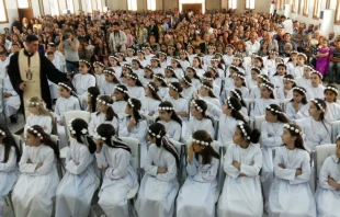 Refugee children in Erbil receive their First Communion May 27, 2016. Photo courtesy of Deacon Roni Momica.