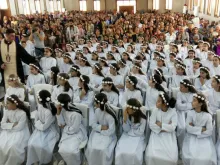 Refugee children in Erbil receive their First Communion May 27, 2016. Photo courtesy of Deacon Roni Momica.
